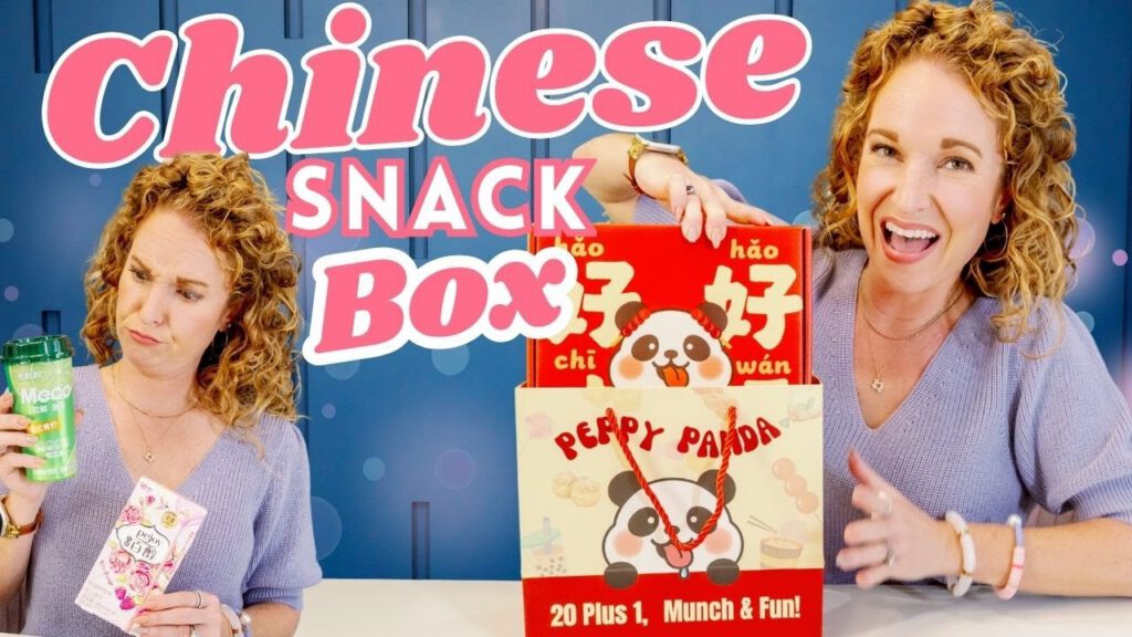Person unboxing Peppy Panda Snack Box featuring Chinese snacks with a playful expression.
