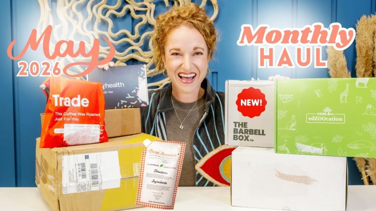 Person with subscription boxes from the May 2026 monthly haul